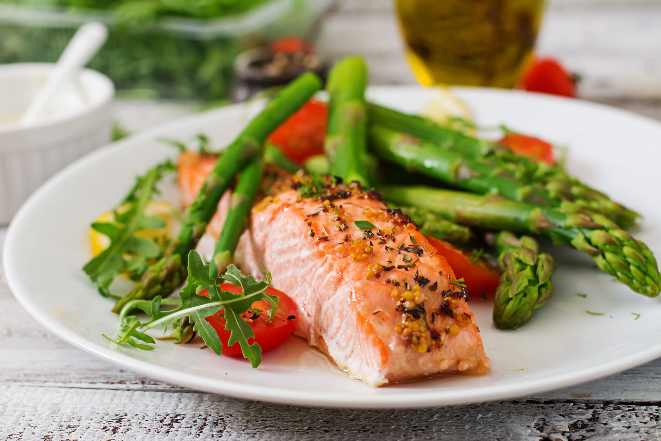 Vendor meal - plated salmon dish Plated salmon with asparagus and tomatoes served at a wedding vendor meal