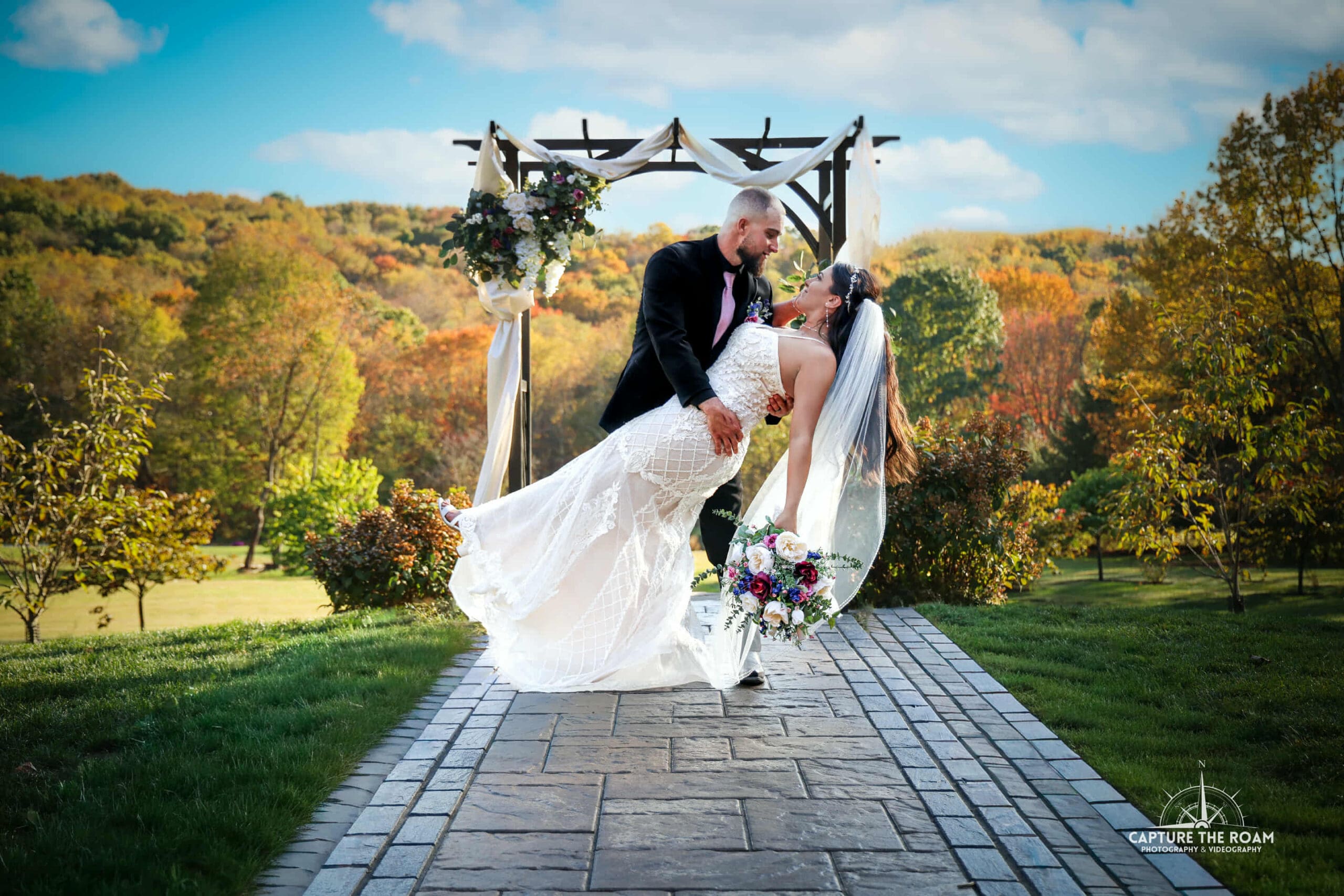 Pittsburgh Wedding Ceremony Decor Arch Bride and groom under floral ceremony arch at Pittsburgh wedding venue